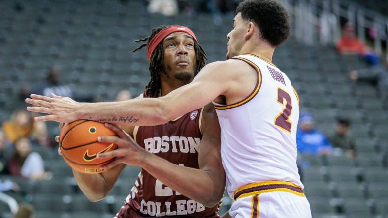 Nov 23, 2023; Kansas City, Missouri, USA; Boston College Eagles forward Devin McGlockton (21) tries to get around Loyola (Il) Ramblers guard Jalen Quinn (2) during the first half at T-Mobile Center. Mandatory Credit: William Purnell-USA TODAY Sports