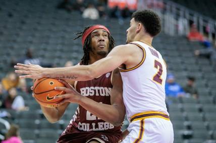 Nov 23, 2023; Kansas City, Missouri, USA; Boston College Eagles forward Devin McGlockton (21) tries to get around Loyola (Il) Ramblers guard Jalen Quinn (2) during the first half at T-Mobile Center. Mandatory Credit: William Purnell-USA TODAY Sports