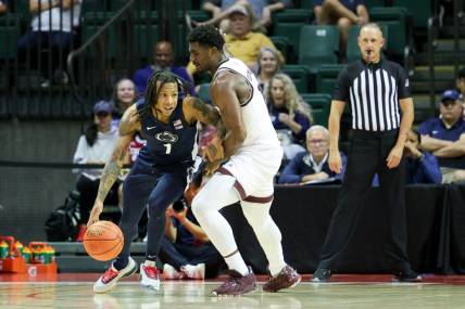Nov 23, 2023; Kissimmee, FL, USA;  Texas A&M Aggies forward Henry Coleman III (15) guards Penn State Nittany Lions guard Ace Baldwin Jr. (1) in the second half during the ESPN Events Invitational at State Farm Field House. Mandatory Credit: Nathan Ray Seebeck-USA TODAY Sports