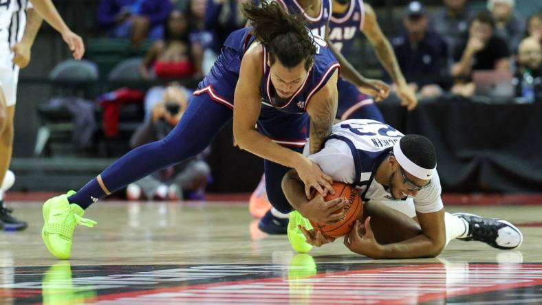 Nov 23, 2023; Kissimmee, Florida, USA;  Florida Atlantic Owls forward Tre Carroll (25) and Butler Bulldogs center Andre Screen (23) fight for a loose ball in the first half during the ESPN Events Invitational at State Farm Field House. Mandatory Credit: Nathan Ray Seebeck-USA TODAY Sports