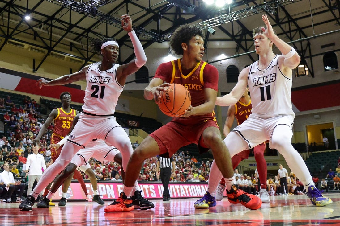 Nov 23, 2023; Kissimmee, Florida, USA;  Iowa State Cyclones guard Curtis Jones (5) look to pass the ball guarded by Virginia Commonwealth Rams forward Christian Fermin (21) and guard Max Shulga (11) in the first half  in the first half during the ESPN Events Invitational at State Farm Field House. Mandatory Credit: Nathan Ray Seebeck-USA TODAY Sports