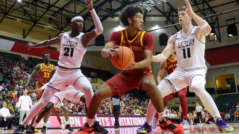 Nov 23, 2023; Kissimmee, Florida, USA;  Iowa State Cyclones guard Curtis Jones (5) look to pass the ball guarded by Virginia Commonwealth Rams forward Christian Fermin (21) and guard Max Shulga (11) in the first half  in the first half during the ESPN Events Invitational at State Farm Field House. Mandatory Credit: Nathan Ray Seebeck-USA TODAY Sports