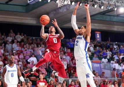 Nov 23, 2023; Paradise Island, BAHAMAS;  Arkansas Razorbacks guard Khalif Battle (0) shoots as Memphis Tigers forward Nick Jourdain (2) defends during the second half at Imperial Arena. Mandatory Credit: Kevin Jairaj-USA TODAY Sports