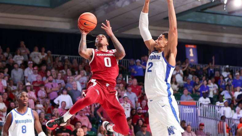 Nov 23, 2023; Paradise Island, BAHAMAS;  Arkansas Razorbacks guard Khalif Battle (0) shoots as Memphis Tigers forward Nick Jourdain (2) defends during the second half at Imperial Arena. Mandatory Credit: Kevin Jairaj-USA TODAY Sports