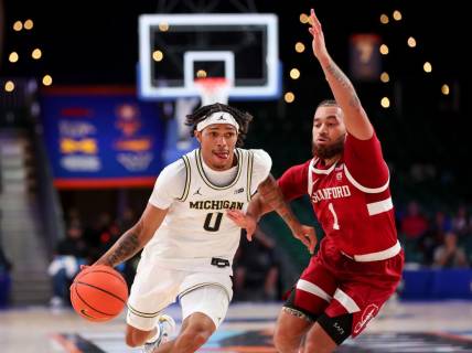 Nov 23, 2023; Paradise Island, BAHAMAS;  Michigan Wolverines guard Dug McDaniel (0) drives to the basket as Stanford Cardinal guard Jared Bynum (1) defends during the first half at Imperial Arena. Mandatory Credit: Kevin Jairaj-USA TODAY Sports