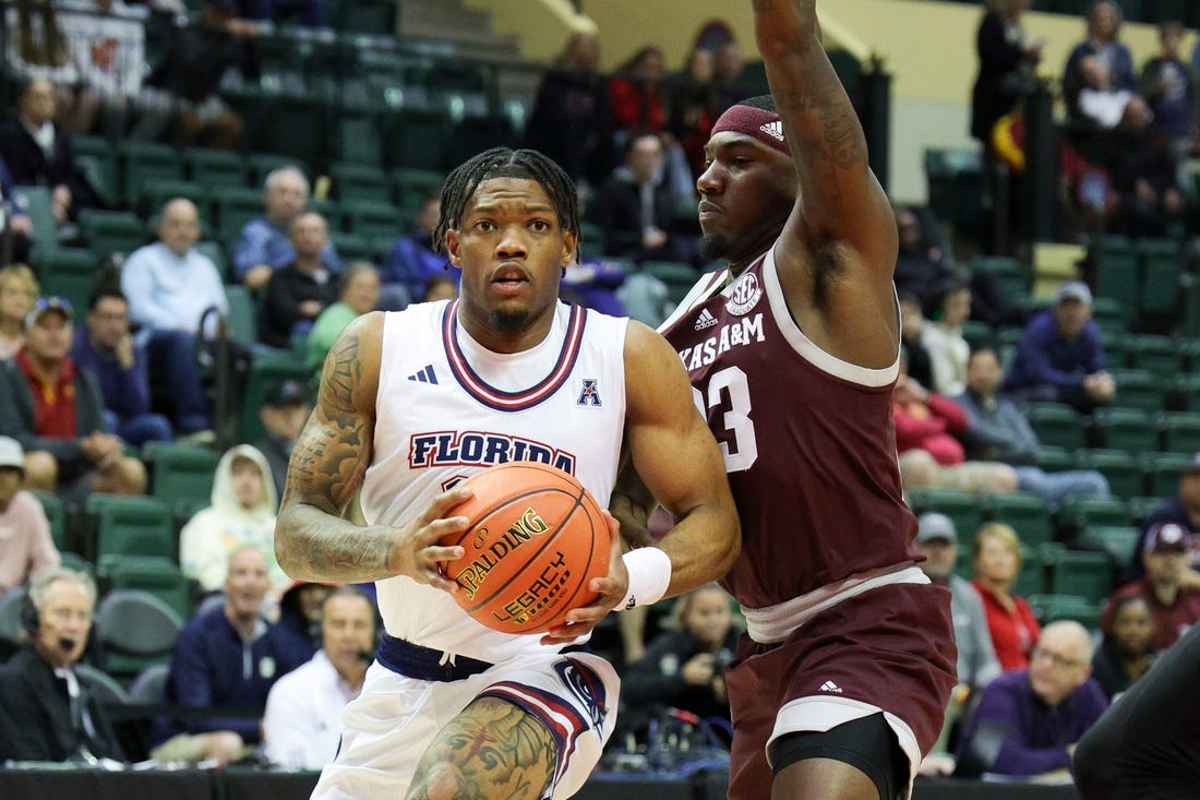 Nov 24, 2023; Kissimmee, FL, USA;Florida Atlantic Owls guard Alijah Martin (15) drives to the hoop guarded by Texas A&M Aggies guard Tyrece Radford (23) in the first half  during the ESPN Events Invitational Semifinals at State Farm Field House. Mandatory Credit: Nathan Ray Seebeck-USA TODAY Sports