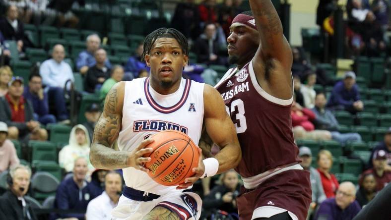 Nov 24, 2023; Kissimmee, FL, USA;Florida Atlantic Owls guard Alijah Martin (15) drives to the hoop guarded by Texas A&M Aggies guard Tyrece Radford (23) in the first half  during the ESPN Events Invitational Semifinals at State Farm Field House. Mandatory Credit: Nathan Ray Seebeck-USA TODAY Sports