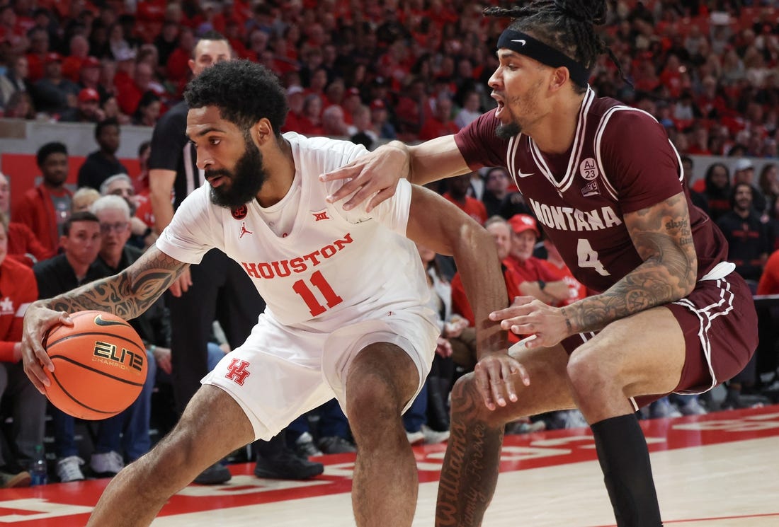 Nov 24, 2023; Houston, Texas, USA;  Houston Cougars guard Damian Dunn (11) dribbles against Montana Grizzlies guard Giordan Williams (4) in the first half at Fertitta Center. Mandatory Credit: Thomas Shea-USA TODAY Sports