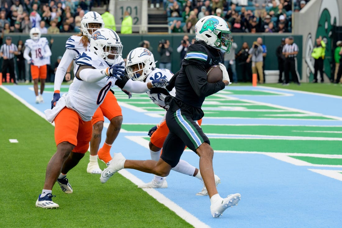 Nov 24, 2023; New Orleans, Louisiana, USA; Tulane Green Wave wide receiver Chris Brazzell II (17) runs around UTSA Roadrunners defensive back Ken Robinson (21) for a touchdown during the first half at Yulman Stadium. Mandatory Credit: Matthew Hinton-USA TODAY Sports