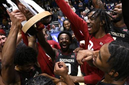 Nov 24, 2023; La Jolla, California, USA; Oklahoma Sooners players celebrate with the championship trophy after defeating USC Trojans at LionTree Arena. Mandatory Credit: Orlando Ramirez-USA TODAY Sports