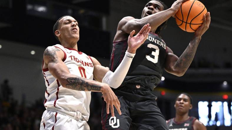 Nov 24, 2023; La Jolla, California, USA; Oklahoma Sooners guard Otega Oweh (3) goes to the basket while defended by USC Trojans guard Kobe Johnson (0) during the second half at LionTree Arena. Mandatory Credit: Orlando Ramirez-USA TODAY Sports