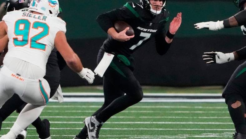 Nov 24, 2023; East Rutherford, New Jersey, USA; New York Jets quarterback Tim Boyle (7) scrambles against the Miami Dolphins in the second half at MetLife Stadium. Mandatory Credit: Robert Deutsch-USA TODAY Sports