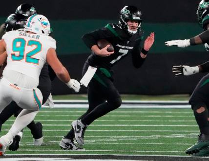 Nov 24, 2023; East Rutherford, New Jersey, USA; New York Jets quarterback Tim Boyle (7) scrambles against the Miami Dolphins in the second half at MetLife Stadium. Mandatory Credit: Robert Deutsch-USA TODAY Sports