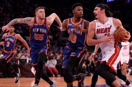 Nov 24, 2023; New York, New York, USA; Miami Heat guard Jaime Jaquez Jr. (11) drives to the basket against New York Knicks guard RJ Barrett (9) and center Isaiah Hartenstein (55) during the second quarter at Madison Square Garden. Mandatory Credit: Brad Penner-USA TODAY Sports