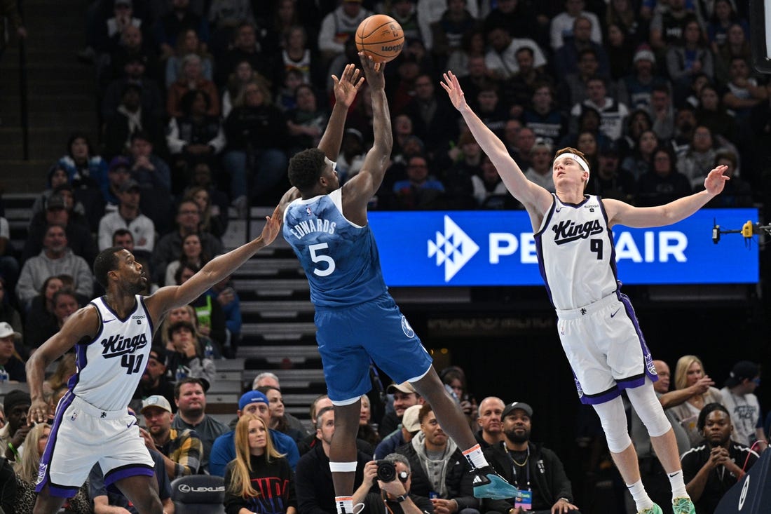 Nov 24, 2023; Minneapolis, Minnesota, USA; Sacramento Kings forward Harrison Barnes (40) and guard Kevin Huerter (9) defend the shot of Minnesota Timberwolves guard Anthony Edwards (5) during the first quarter at Target Center. Mandatory Credit: Jeffrey Becker-USA TODAY Sports