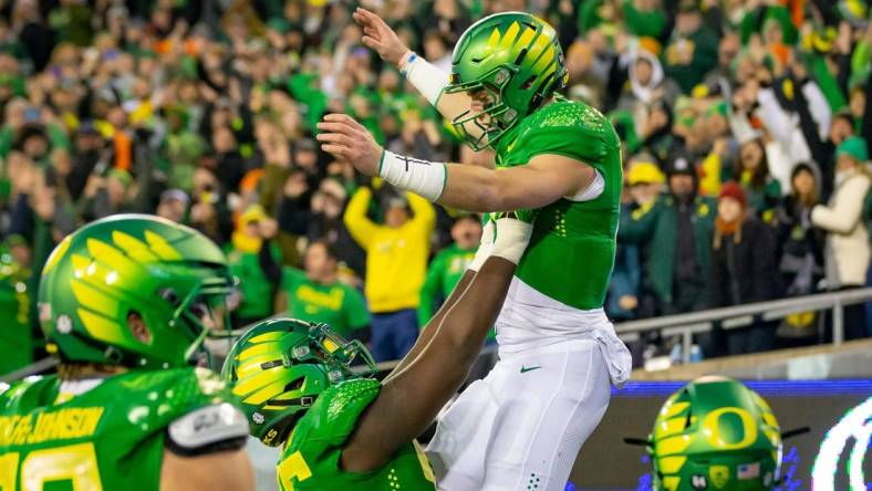 Oregon quarterback Bo Nix is hoisted into the air after a touchdown as the No. 6 Oregon Ducks take on the No. 16 Oregon State Beavers Friday, Nov. 24, 2023, at Autzen Stadium in Eugene, Ore.