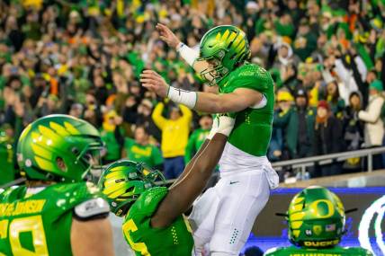 Oregon quarterback Bo Nix is hoisted into the air after a touchdown as the No. 6 Oregon Ducks take on the No. 16 Oregon State Beavers Friday, Nov. 24, 2023, at Autzen Stadium in Eugene, Ore.