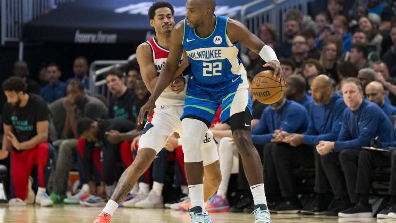 Nov 24, 2023; Milwaukee, Wisconsin, USA;  Milwaukee Bucks forward Khris Middleton (22) dribbles the ball as Washington Wizards guard Jordan Poole (13) defends during the first quarter at Fiserv Forum. Mandatory Credit: Jeff Hanisch-USA TODAY Sports