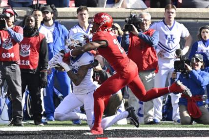 Nov 25, 2023; Louisville, Kentucky, USA;  Kentucky Wildcats wide receiver Dane Key (6) catches a touchdown pass under the pressure of Louisville Cardinals defensive back Storm Duck (29) during the first half at L&N Federal Credit Union Stadium. Mandatory Credit: Jamie Rhodes-USA TODAY Sports