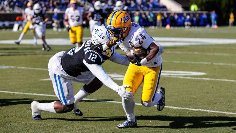 Nov 25, 2023; Durham, North Carolina, USA; Duke Blue Devils linebacker Tre Freeman (12) tacks Pittsburgh Panthers running back C'Bo Flemister (24) during the first half of the game at Wallace Wade Stadium. Mandatory Credit: Jaylynn Nash-USA TODAY Sports