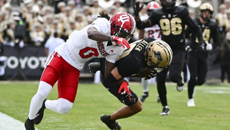 Nov 25, 2023; West Lafayette, Indiana, USA; Purdue Boilermakers defensive back Cam Allen (10) intercepts a pass intended for Indiana Hoosiers wide receiver Andison Coby (0) during the first half at Ross-Ade Stadium. Mandatory Credit: Robert Goddin-USA TODAY Sports