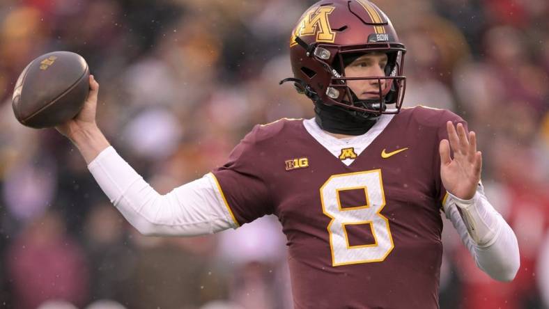 Nov 25, 2023; Minneapolis, Minnesota, USA;  Minnesota Golden Gophers quarterback Athan Kaliakmanis (8) makes a throw against the Wisconsin Badgers during the second quarter at Huntington Bank Stadium. Mandatory Credit: Nick Wosika-USA TODAY Sports