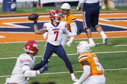 Nov 25, 2023; El Paso, Texas, USA; No. 22 Liberty Flames quarterback Kaidon Salter (7) tries throws the ball against the UTEP Miners defense during the first half at Sun Bowl Stadium. Mandatory Credit: Ivan Pierre Aguirre-USA TODAY Sports