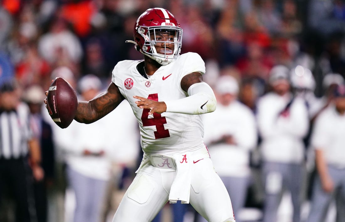 Nov 25, 2023; Auburn, Alabama, USA; Alabama Crimson Tide quarterback Jalen Milroe (4) drops back to pass against the Auburn Tigers during the fourth quarter at Jordan-Hare Stadium. Mandatory Credit: John David Mercer-USA TODAY Sports