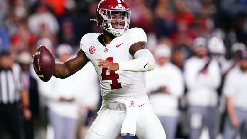 Nov 25, 2023; Auburn, Alabama, USA; Alabama Crimson Tide quarterback Jalen Milroe (4) drops back to pass against the Auburn Tigers during the fourth quarter at Jordan-Hare Stadium. Mandatory Credit: John David Mercer-USA TODAY Sports