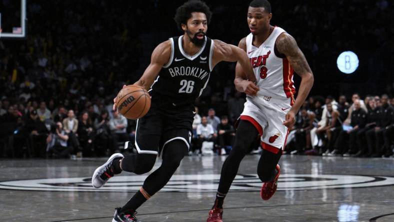 Nov 25, 2023; Brooklyn, New York, USA; Brooklyn Nets guard Spencer Dinwiddie (26) drives against Miami Heat forward Jamal Cain (8) during the fourth quarter at Barclays Center. Mandatory Credit: John Jones-USA TODAY Sports