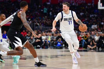 Nov 25, 2023; Los Angeles, California, USA; Dallas Mavericks guard Luka Doncic (77) controls the ball against the Los Angeles Clippers during the second half Crypto.com Arena. Mandatory Credit: Gary A. Vasquez-USA TODAY Sports
