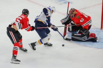 Nov 26, 2023; Chicago, Illinois, USA; St. Louis Blues left wing Jake Neighbours (63) attempts to score against  Chicago Blackhawks goaltender Arvid Soderblom (40) during the first period at United Center. Mandatory Credit: Kamil Krzaczynski-USA TODAY Sports