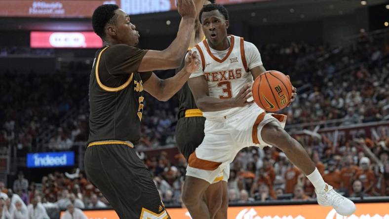 Nov 26, 2023; Austin, Texas, USA; Texas Longhorns guard Max Abmas (3) passes the ball while defended by Wyoming Cowboys forward Cam Manyawu (5) during the first half at Moody Center. Mandatory Credit: Scott Wachter-USA TODAY Sports