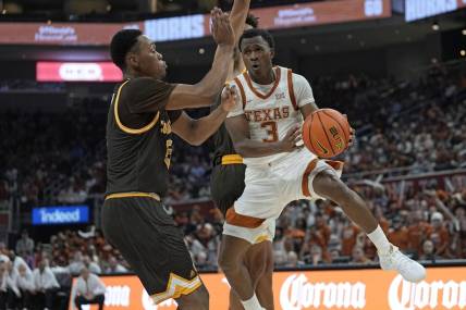Nov 26, 2023; Austin, Texas, USA; Texas Longhorns guard Max Abmas (3) passes the ball while defended by Wyoming Cowboys forward Cam Manyawu (5) during the first half at Moody Center. Mandatory Credit: Scott Wachter-USA TODAY Sports