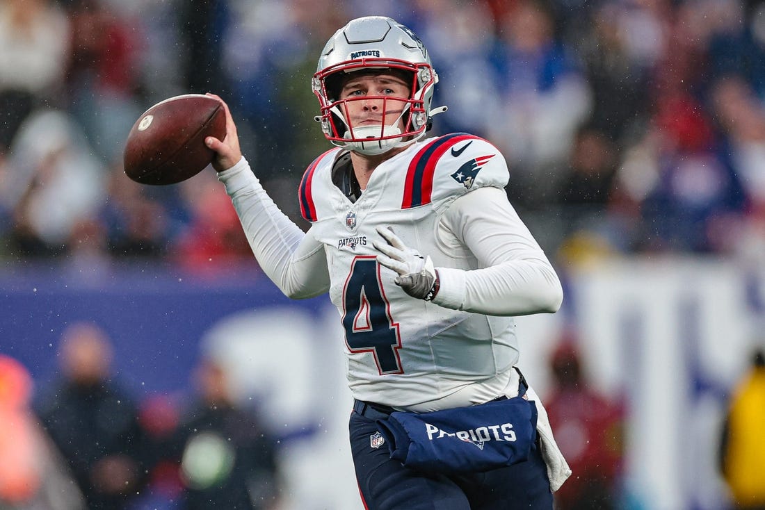 Nov 26, 2023; East Rutherford, New Jersey, USA; New England Patriots quarterback Bailey Zappe (4) throws the ball during the second half against the New York Giants at MetLife Stadium. Mandatory Credit: Vincent Carchietta-USA TODAY Sports