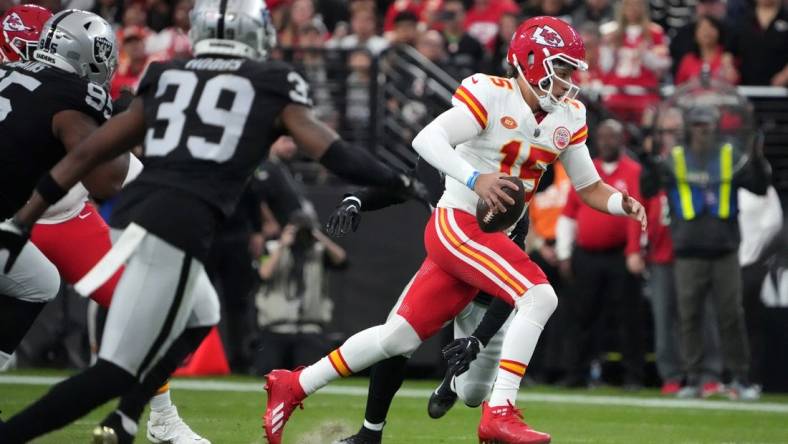 Nov 26, 2023; Paradise, Nevada, USA; Kansas City Chiefs quarterback Patrick Mahomes (15) carries the ball against the Las Vegas Raiders in the first half at Allegiant Stadium. Mandatory Credit: Kirby Lee-USA TODAY Sports