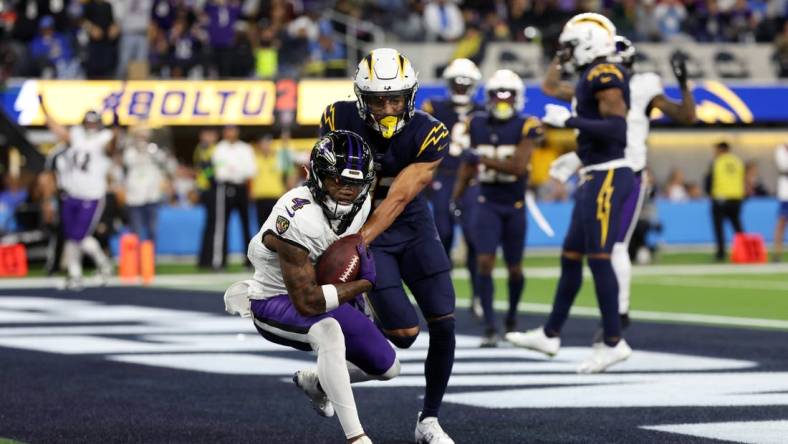 Nov 26, 2023; Inglewood, California, USA; Baltimore Ravens wide receiver Zay Flowers (4) catches a touchdown pass during the second quarter against the Los Angeles Chargers at SoFi Stadium. Mandatory Credit: Kiyoshi Mio-USA TODAY Sports