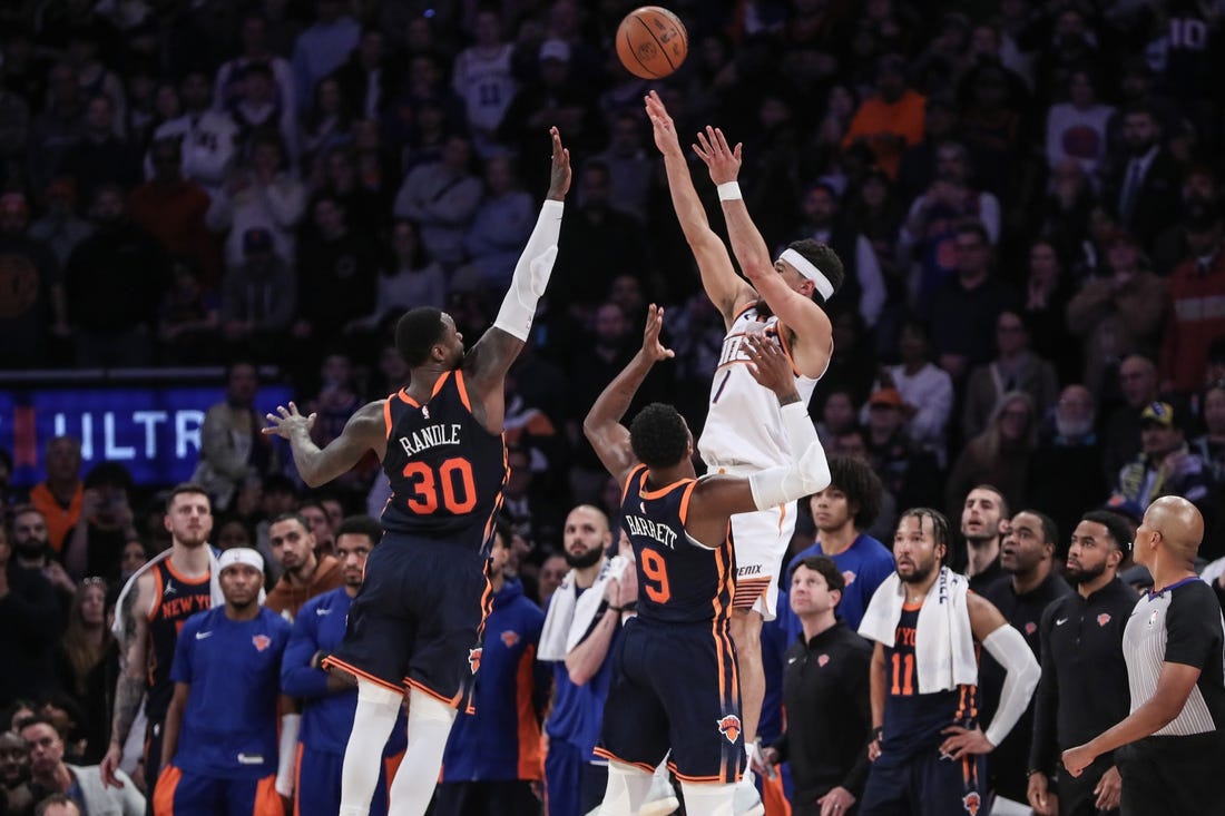 Nov 26, 2023; New York, New York, USA; Phoenix Suns guard Devin Booker (1) takes the game winning three-point shot in the fourth quarter against the New York Knicks at Madison Square Garden. Mandatory Credit: Wendell Cruz-USA TODAY Sports