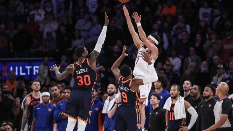 Nov 26, 2023; New York, New York, USA; Phoenix Suns guard Devin Booker (1) takes the game winning three-point shot in the fourth quarter against the New York Knicks at Madison Square Garden. Mandatory Credit: Wendell Cruz-USA TODAY Sports