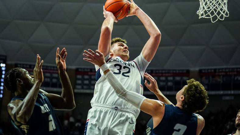 Nov 27, 2023; Storrs, Connecticut, USA; UConn Huskies center Donovan Clingan (32) shoots against New Hampshire Wildcats forward Jaxson Baker (3) in the first half at Harry A. Gampel Pavilion. Mandatory Credit: David Butler II-USA TODAY Sports