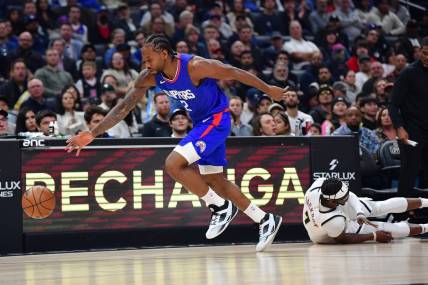 Nov 27, 2023; Los Angeles, California, USA; Los Angeles Clippers forward Kawhi Leonard (2) steals the ball from Denver Nuggets guard Reggie Jackson (7) during the first half at Crypto.com Arena. Mandatory Credit: Gary A. Vasquez-USA TODAY Sports