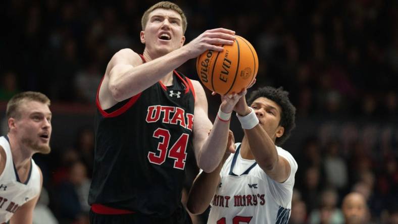 Nov 27, 2023; Moraga, California, USA;  Utah Utes center Lawson Lovering (34) attempts to shoot the ball during the first half against St. Mary's Gaels guard Chris Howell (15) at University Credit Union Pavilion. Mandatory Credit: Stan Szeto-USA TODAY Sports