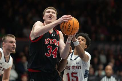 Nov 27, 2023; Moraga, California, USA;  Utah Utes center Lawson Lovering (34) attempts to shoot the ball during the first half against St. Mary's Gaels guard Chris Howell (15) at University Credit Union Pavilion. Mandatory Credit: Stan Szeto-USA TODAY Sports