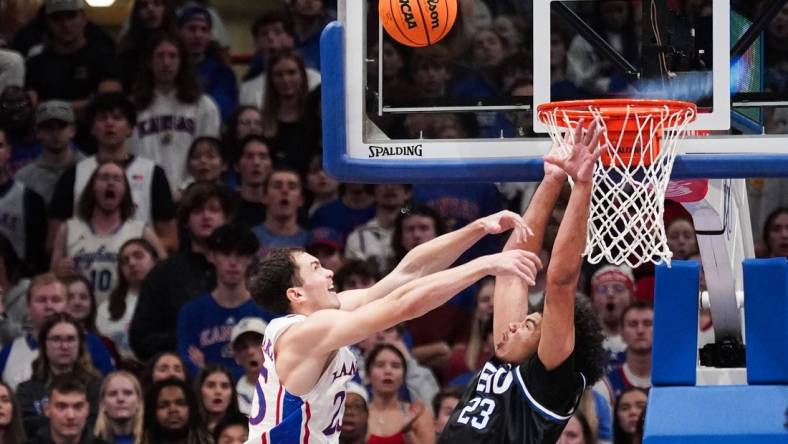 Nov 28, 2023; Lawrence, Kansas, USA; Kansas Jayhawks guard Nicolas Timberlake (25) shoots as Eastern Illinois Panthers forward Rodolfo Bolis (23) attempts to block during the first half at Allen Fieldhouse. Mandatory Credit: Denny Medley-USA TODAY Sports