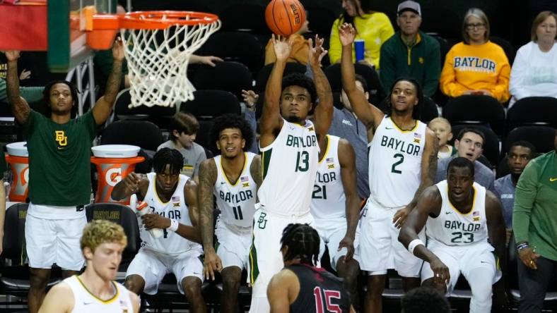 Nov 28, 2023; Waco, Texas, USA; Baylor Bears guard Langston Love (13) scores a three-point basket against Nicholls State Colonels forward Jamal West Jr. (15) during the second half at Ferrell Center. Mandatory Credit: Chris Jones-USA TODAY Sports