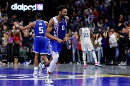 Nov 28, 2023; Sacramento, California, USA; Sacramento Kings guard Malik Monk (0) smiles after scoring a basket during the fourth quarter against the Golden State Warriors at Golden 1 Center. Mandatory Credit: Sergio Estrada-USA TODAY Sports