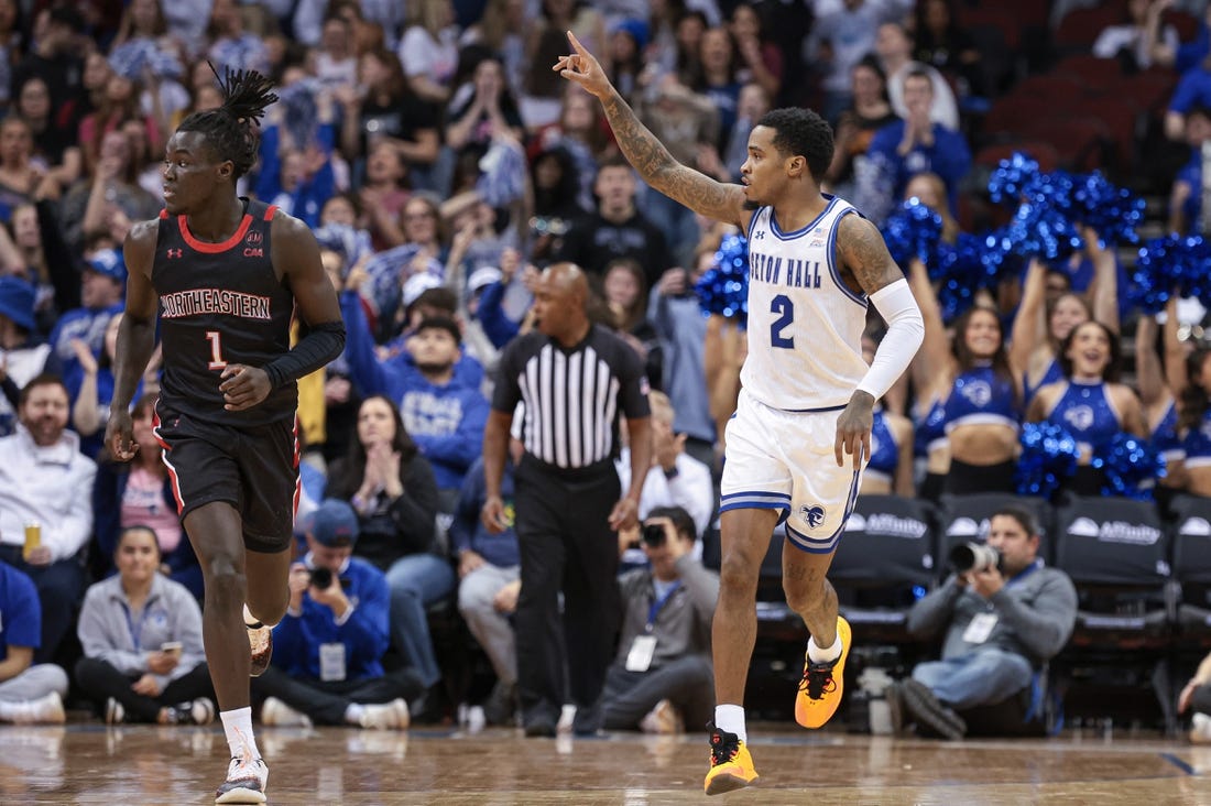 Nov 29, 2023; Newark, New Jersey, USA; Seton Hall Pirates guard Al-Amir Dawes (2) reacts after a basket during the first half in front of Northeastern Huskies guard Masai Troutman (1) at Prudential Center. Mandatory Credit: Vincent Carchietta-USA TODAY Sports