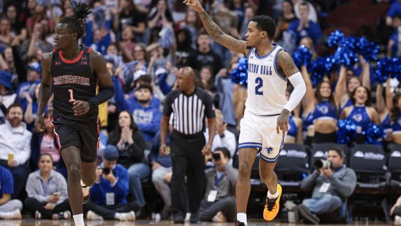 Nov 29, 2023; Newark, New Jersey, USA; Seton Hall Pirates guard Al-Amir Dawes (2) reacts after a basket during the first half in front of Northeastern Huskies guard Masai Troutman (1) at Prudential Center. Mandatory Credit: Vincent Carchietta-USA TODAY Sports