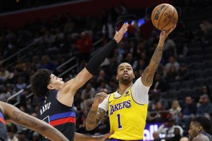 Nov 29, 2023; Detroit, Michigan, USA; Los Angeles Lakers guard D'Angelo Russell (1) shoots on Detroit Pistons guard Killian Hayes (7) in the first half at Little Caesars Arena. Mandatory Credit: Rick Osentoski-USA TODAY Sports