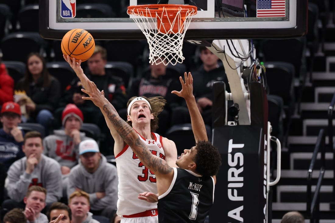 Nov 30, 2023; Salt Lake City, Utah, USA; Utah Utes center Branden Carlson (35) shoots the ball over Hawaii Warriors forward Justin McKoy (1) during the first half at Delta Center. Mandatory Credit: Rob Gray-USA TODAY Sports